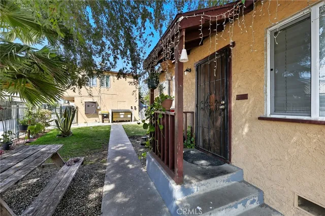 a view of a pathway of a house with a yard