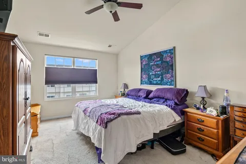 a bedroom with a bed and a flat tv screen