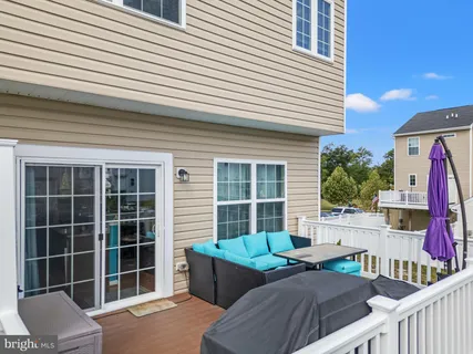 a view of house with a chairs and table in a patio