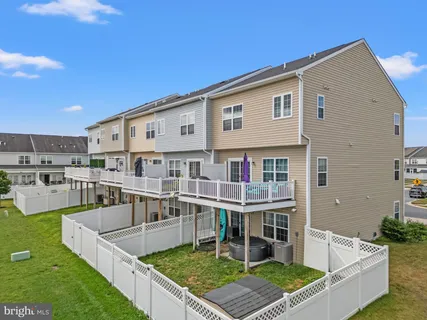 a view of a house with pool and chairs