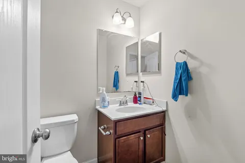 a bathroom with a sink vanity and toilet