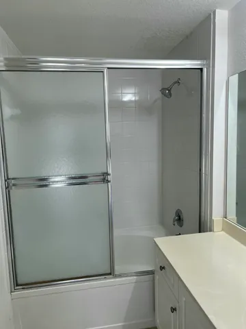 a bathroom with a shower and a sink
