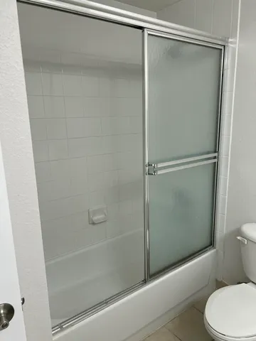 a bathroom with a shower and a toilet