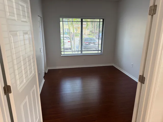 a view of a room with wooden floor and a window
