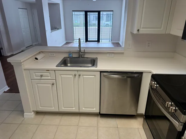 a kitchen with white cabinets and a stove