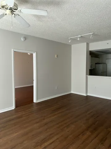 a view of an empty room with wooden floor