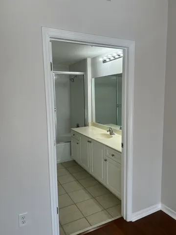 a bathroom with a double vanity sink and mirror