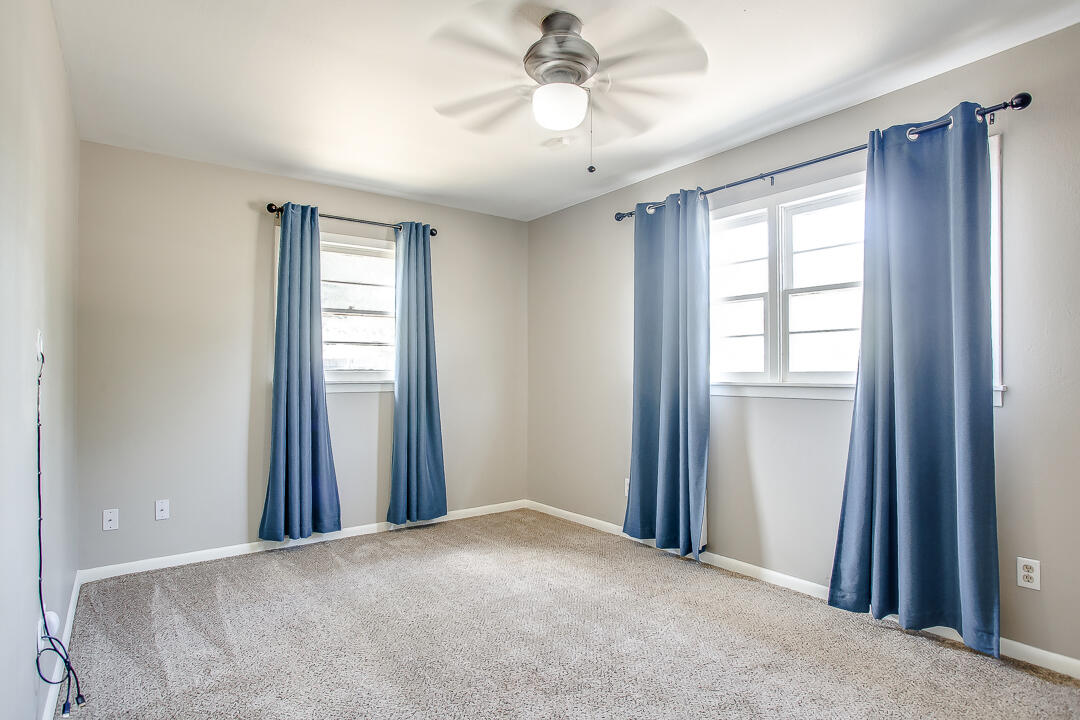 2802 54th Street Lubbock, TX 79413 - Photo 9 of 14 an empty room with windows and fan