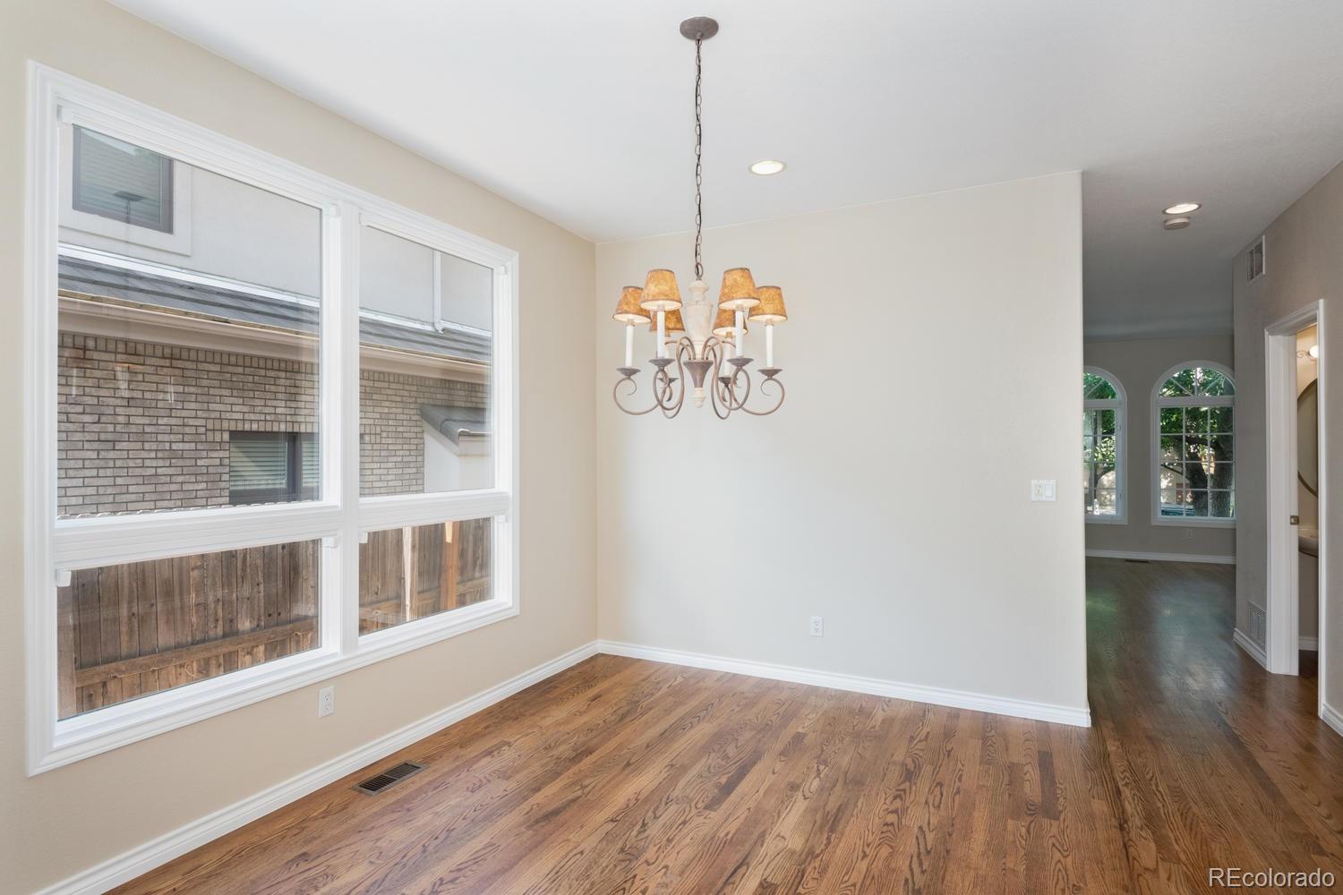 210 Cook Street Denver, CO 80206 - Photo 11 of 26 a view of a room with wooden floor and windows