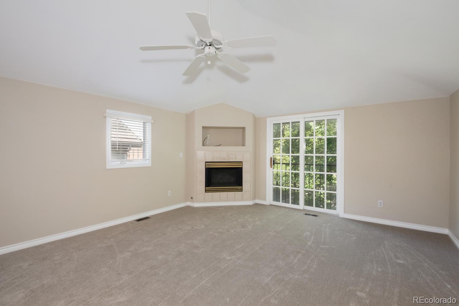 210 Cook Street Denver, CO 80206 - Photo 14 of 26 a view of an empty room with a fireplace and a window
