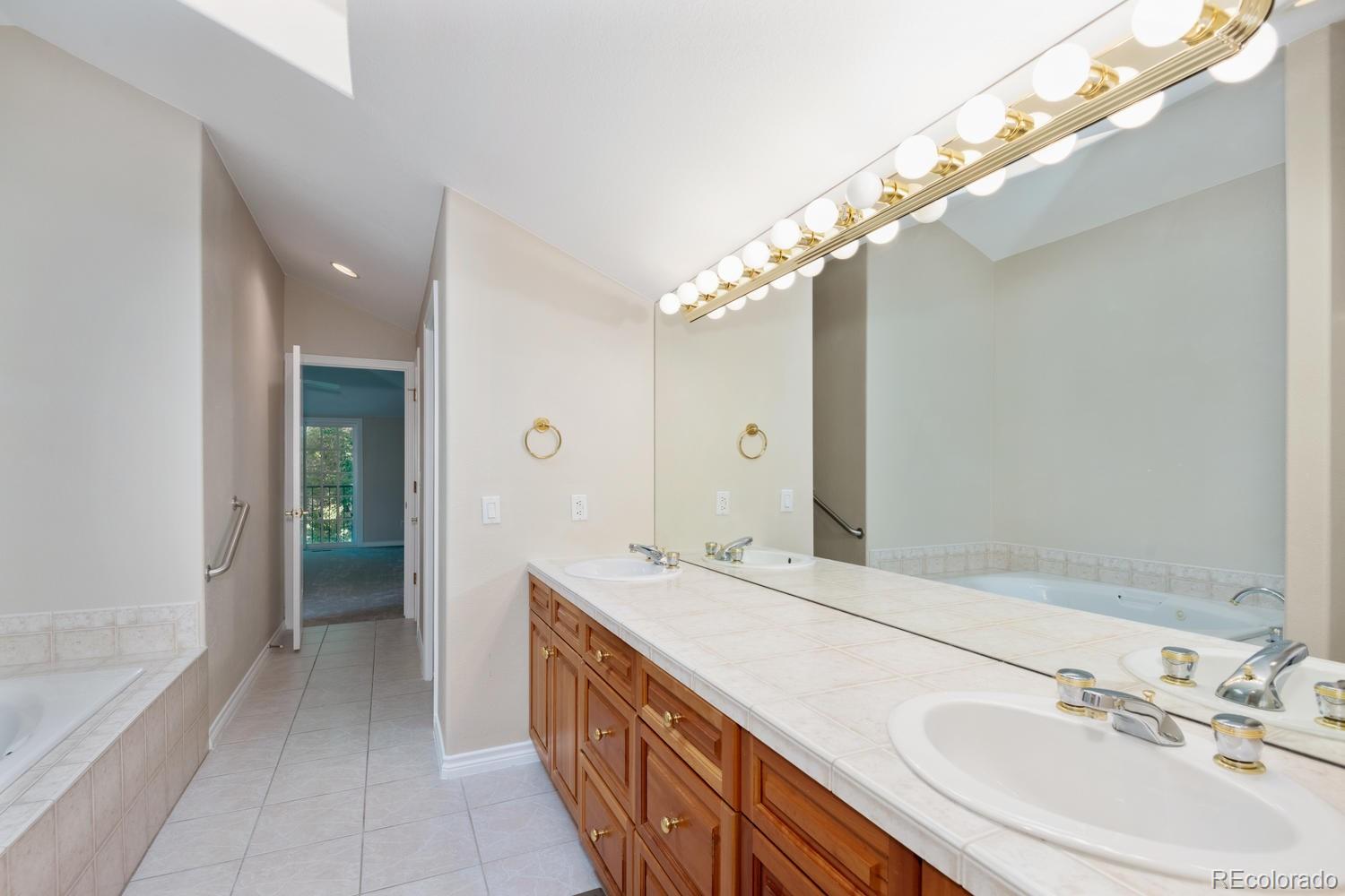 210 Cook Street Denver, CO 80206 - Photo 16 of 26 a bathroom with a double vanity sink and a mirror