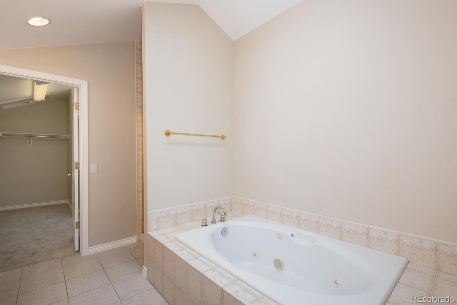 210 Cook Street Denver, CO 80206 - Photo 17 of 26 a white bath tub sitting in a bathroom