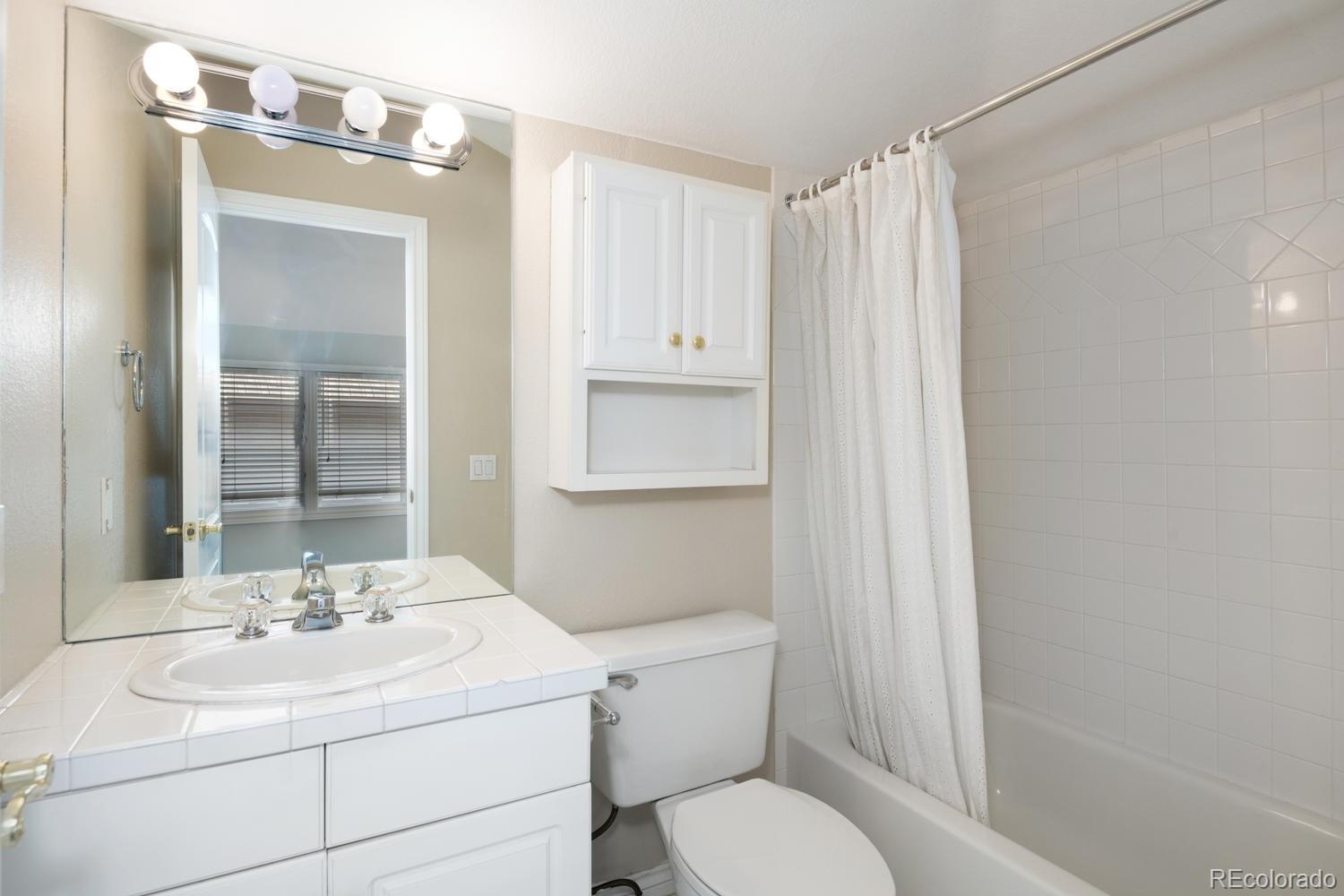 210 Cook Street Denver, CO 80206 - Photo 20 of 26 a bathroom with a sink toilet and shower