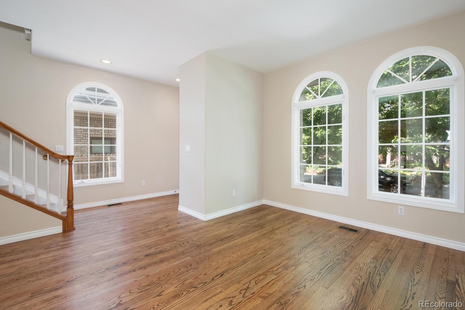 210 Cook Street Denver, CO 80206 - Photo 2 of 26 an empty room with wooden floor and windows