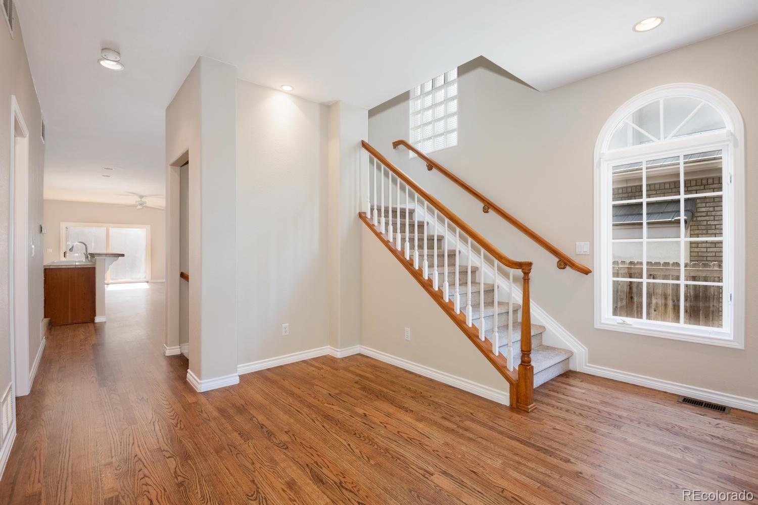210 Cook Street Denver, CO 80206 - Photo 4 of 26 a view of entryway with wooden floor and stairs