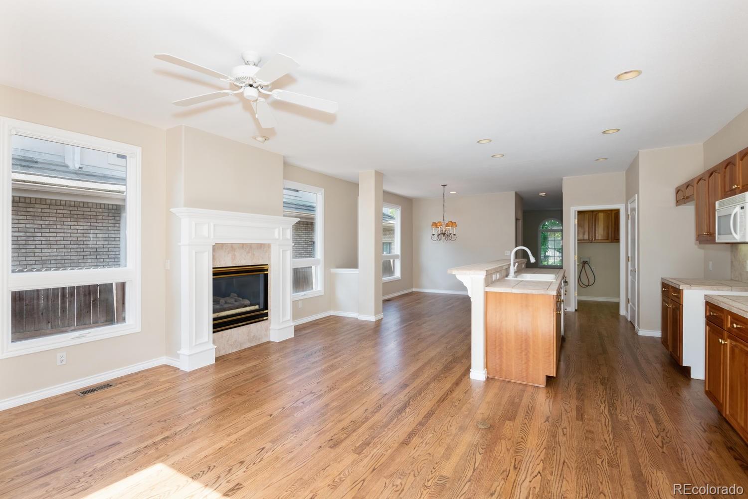 210 Cook Street Denver, CO 80206 - Photo 9 of 26 a living room with furniture a fireplace and wooden floor
