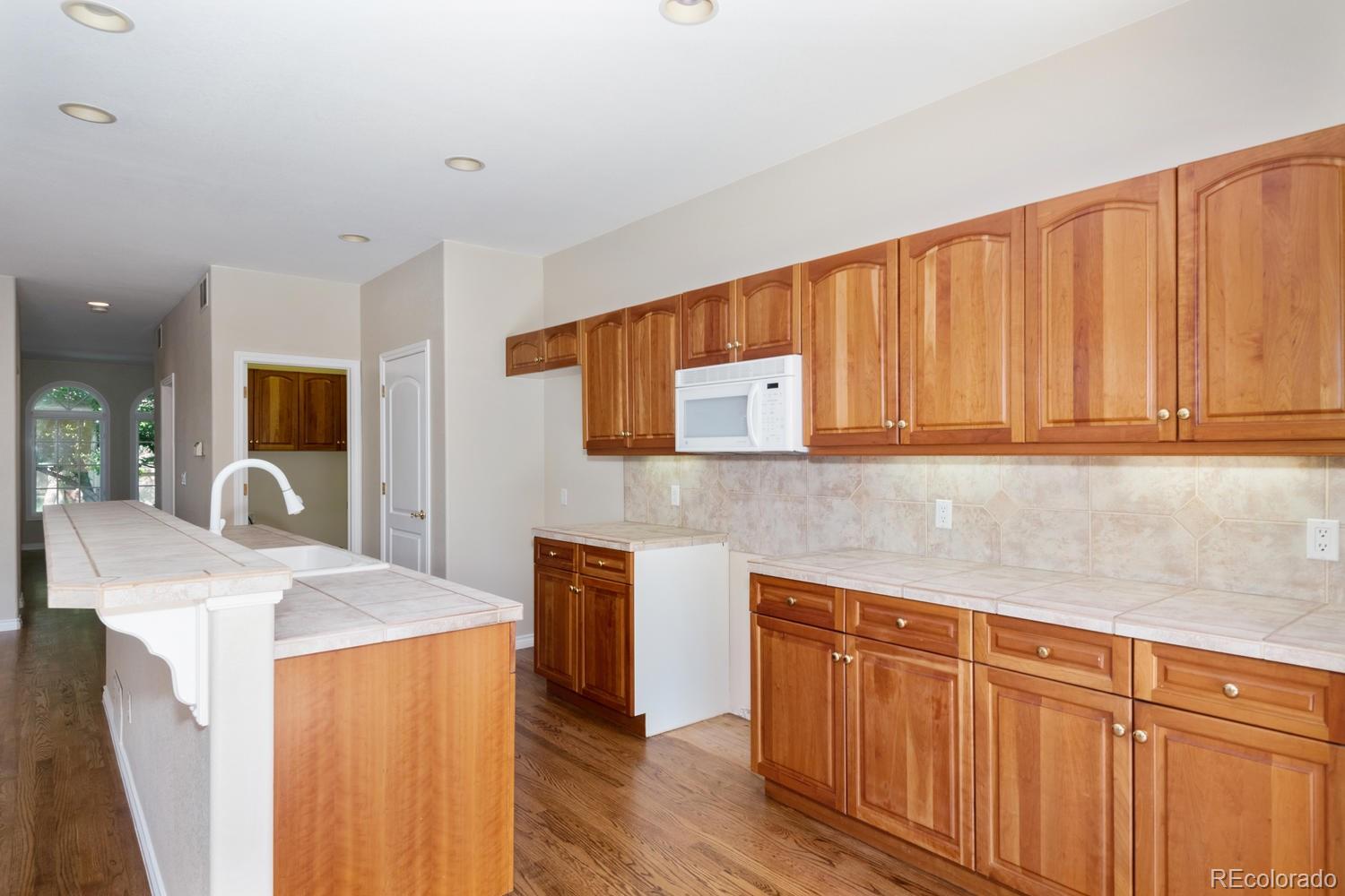 210 Cook Street Denver, CO 80206 - Photo 10 of 26 a kitchen with stainless steel appliances granite countertop wooden cabinets a sink and dishwasher