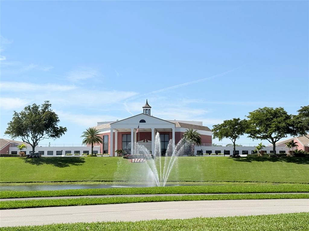 53 Markham C, Unit 53 Deerfield Beach, FL 33442 - Photo 24 of 30 a front view of a house with a yard