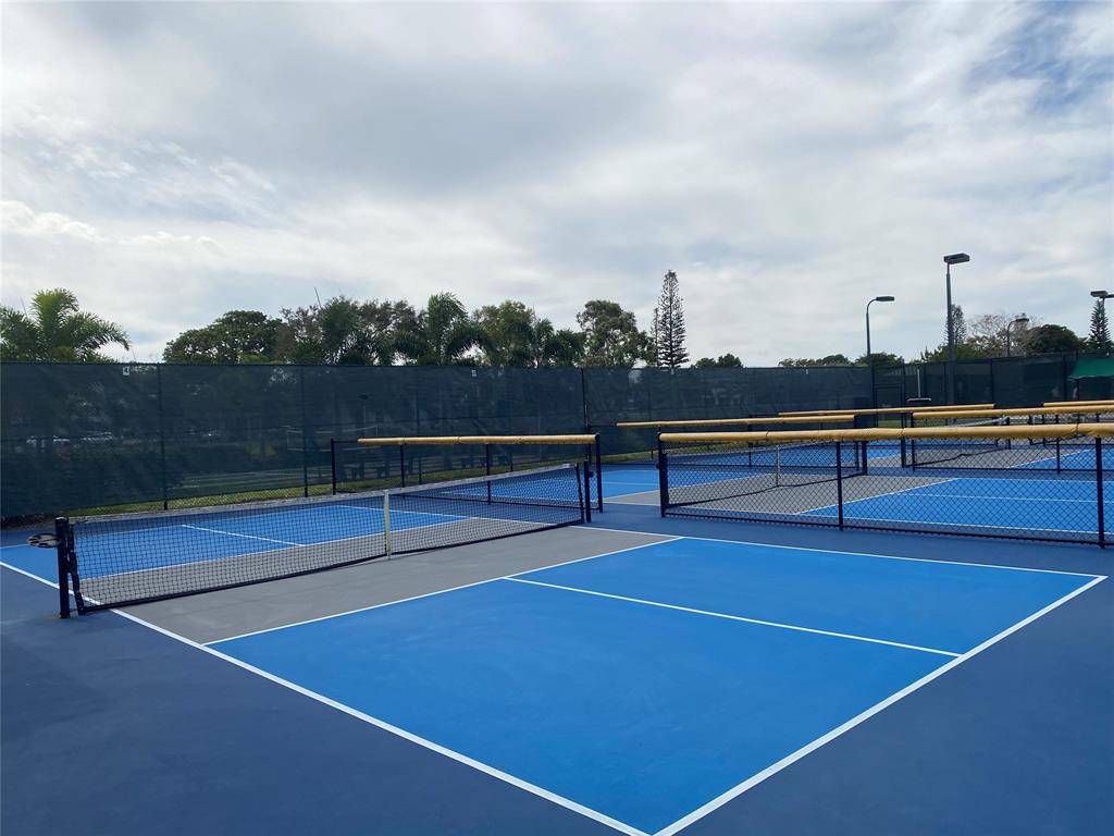53 Markham C, Unit 53 Deerfield Beach, FL 33442 - Photo 28 of 30 a view of tennis court with houses