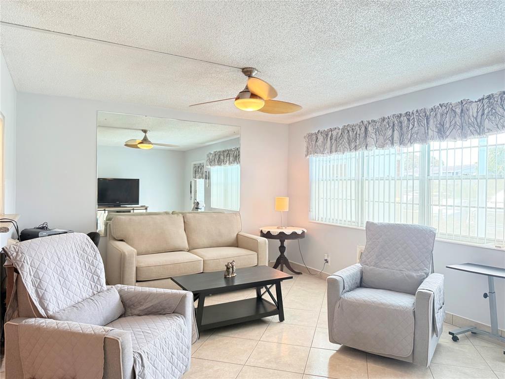 53 Markham C, Unit 53 Deerfield Beach, FL 33442 - Photo 5 of 30 a living room with furniture and a large window