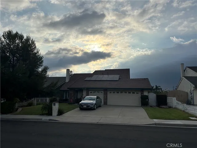 a view of a house with a yard and pathway