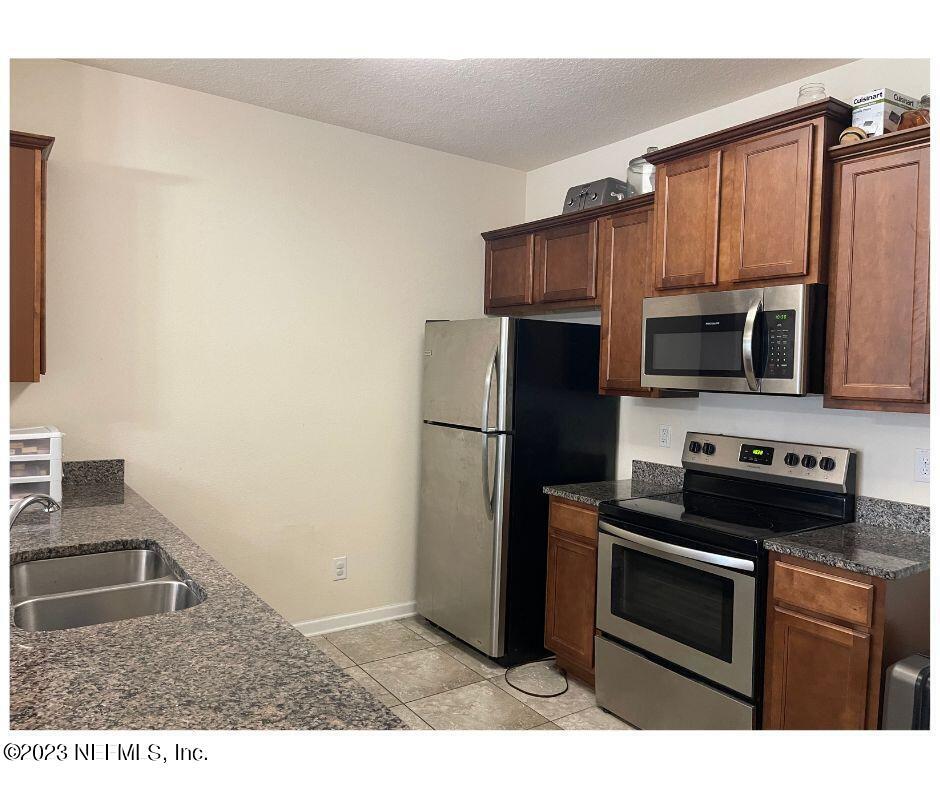 343 Servia Drive St. Johns, FL 32259 - Photo 3 of 8 a kitchen with a refrigerator stove and microwave