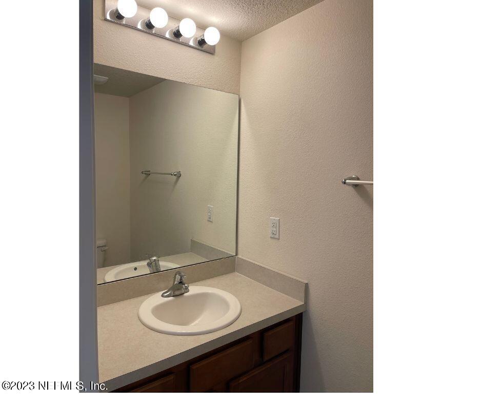 343 Servia Drive St. Johns, FL 32259 - Photo 4 of 8 a bathroom with a sink and a mirror