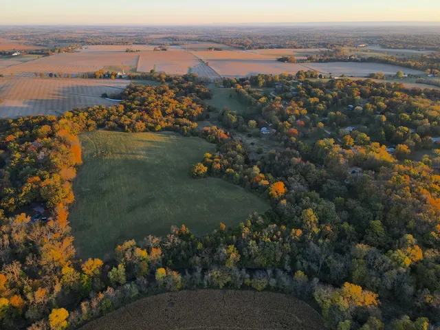 an aerial view of lake and residential houses with outdoor space