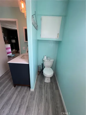 a bathroom with a toilet and a mirror