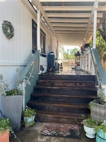 a front view of a house with a garden and patio