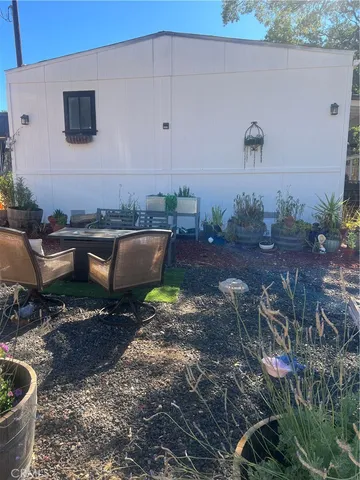 a view of a backyard with plants and outdoor seating