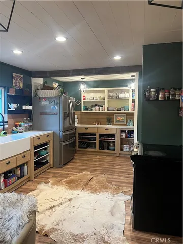 a view of a kitchen with stainless steel appliances double vanity and a counter top