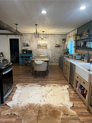 a kitchen with a sink a counter top space appliances and cabinets
