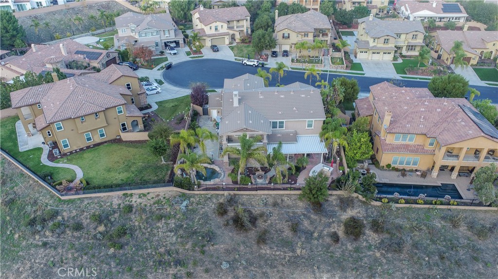 8111 Sunset Rose Drive Corona, CA 92883 - Photo 19 of 19 an aerial view of residential houses with outdoor space and parking