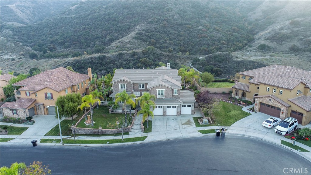 8111 Sunset Rose Drive Corona, CA 92883 - Photo 2 of 19 a front view of a house with a garden and plants