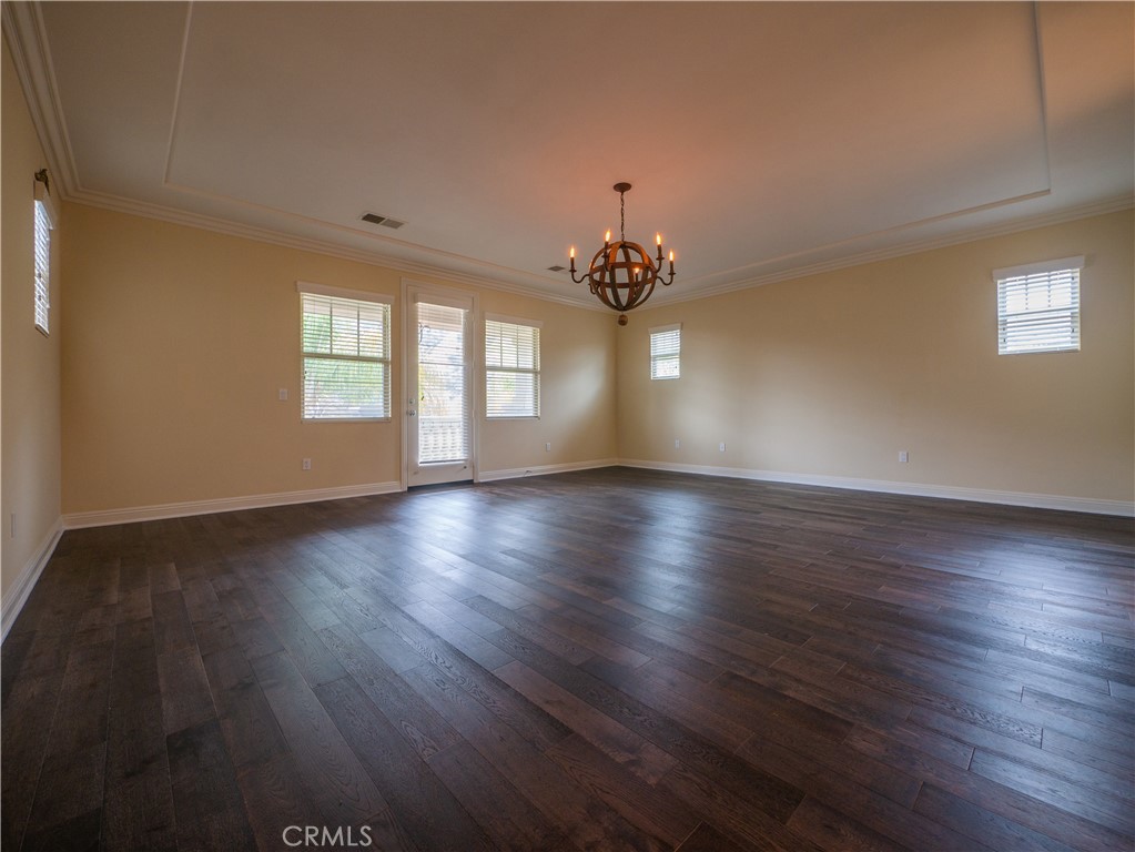 8111 Sunset Rose Drive Corona, CA 92883 - Photo 10 of 19 a view of an empty room with wooden floor and a window