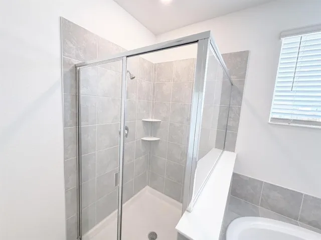 a bathroom with a shower and toilet
