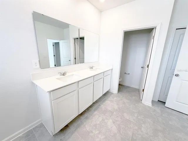 a view of a bathroom with a sink and mirror