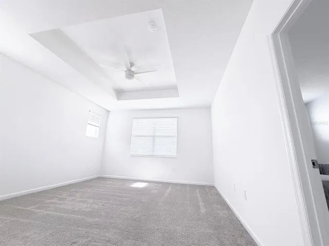 an empty room with a windows and closet