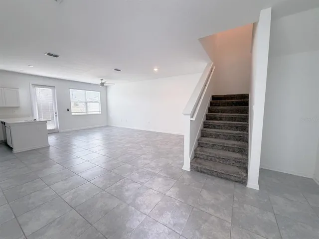 a view of an empty room with stairs