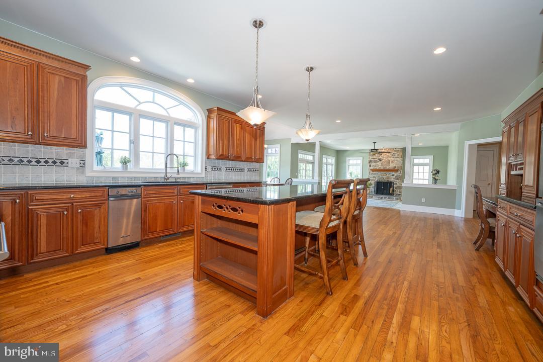 2 Spring Meadows Farm Lane Malvern, PA 19355 - Photo 14 of 63 a kitchen with stainless steel appliances granite countertop wooden floors and sink