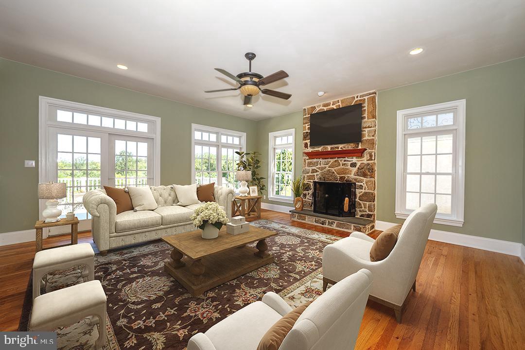 2 Spring Meadows Farm Lane Malvern, PA 19355 - Photo 19 of 63 a living room with furniture a flat screen tv and a fireplace
