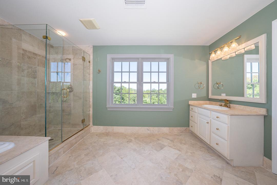 2 Spring Meadows Farm Lane Malvern, PA 19355 - Photo 33 of 63 a bathroom with a granite countertop sink a toilet and shower