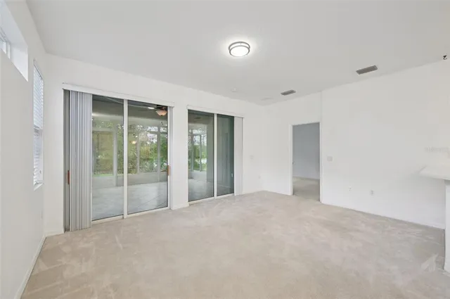 a view of an empty room with glass door