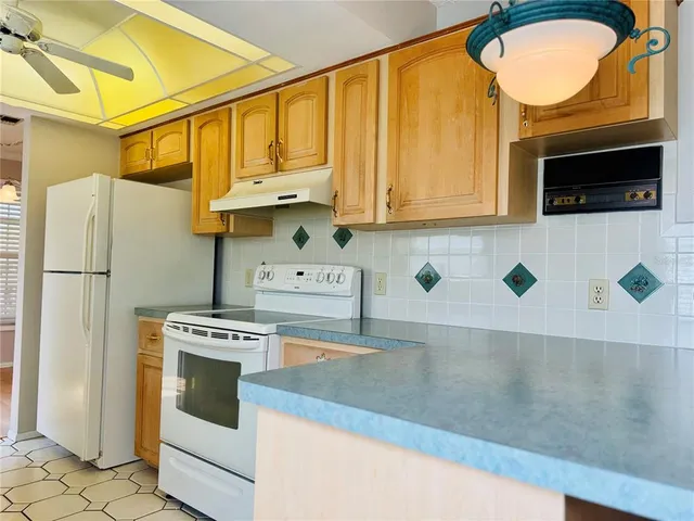 a kitchen with stainless steel appliances granite countertop a stove a microwave and a refrigerator