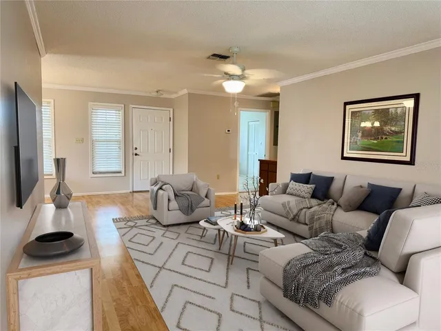a living room with furniture a large window and a flat screen tv