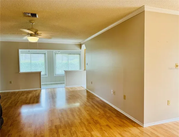 a view of empty room with wooden floor
