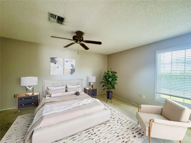 a bedroom with a bed and a couch