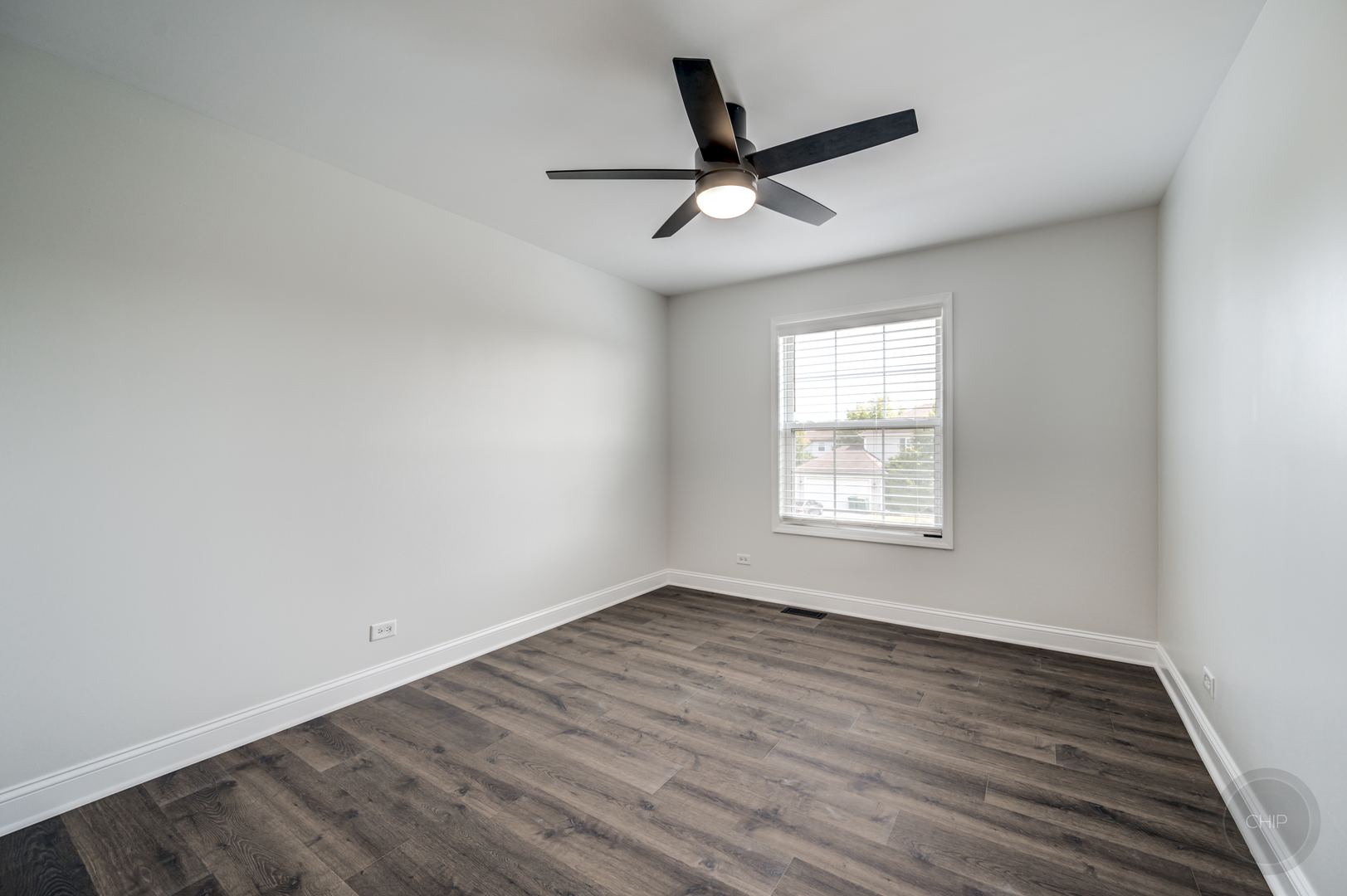 12948 Parterre Place Plainfield, IL 60585 - Photo 21 of 35 an empty room with wooden floor ceiling fan and windows