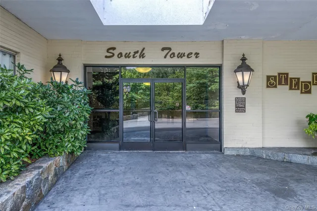 a sign that is sitting in front of flowers